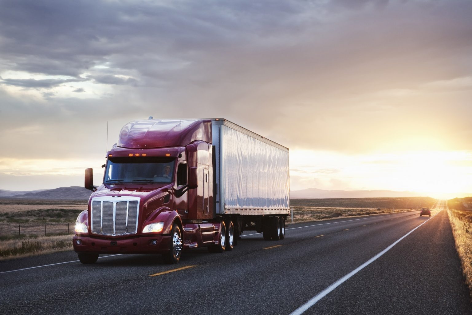 3/4 front view of a commercial truck on the road at sunset in eastern Washington, USA